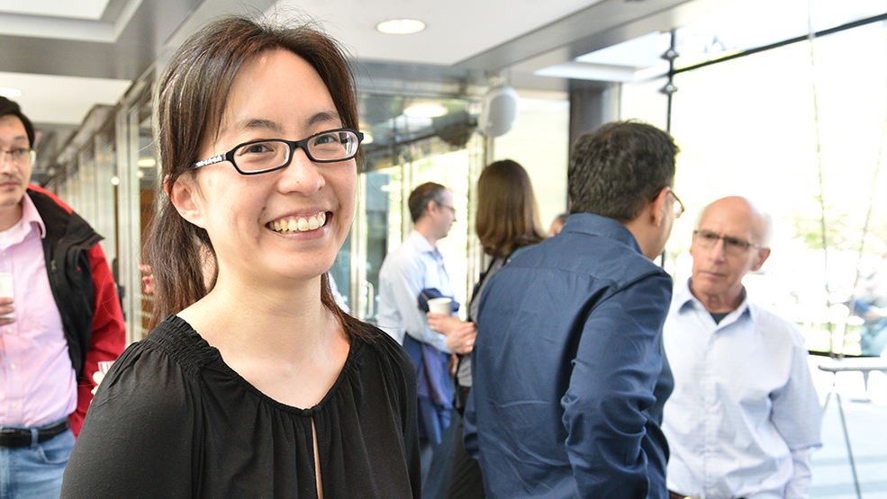 Scientist smiling at a poster session