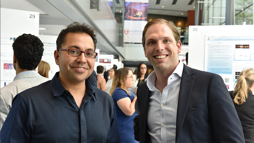 Vikram Khurana and Jon Hoggatt attending a poster session