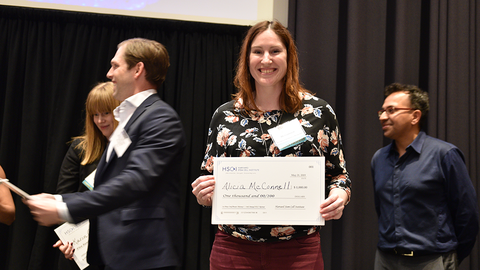 Alicia McConnell standing with her award